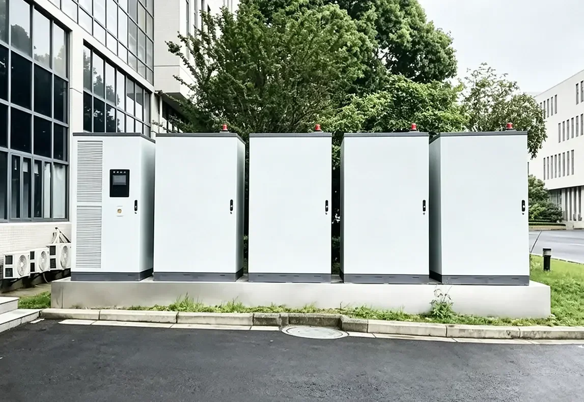Outdoor rack energy storage cabinets installed outside modern industrial office building for factory power backup